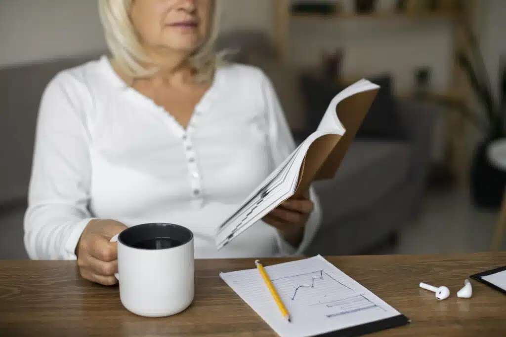 senior-woman-reading-book-her-class